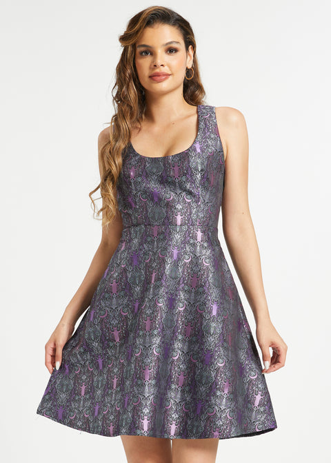 Woman wearing dark academia fit and flare dress with purple bat and moon pattern