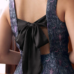 Back view of woman wearing gothic fit and flare dress with open back and oversized black bow