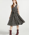 Woman wearing ModCloth Instant Energy Faux-Wrap Dress in Dead Gorgeous featuring a vintage floral skull print, sleeveless V-neck bodice, removable tie belt, and full skirt.