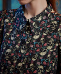 Close-up of women's gothic skull floral print 100% cotton button-up blouse 