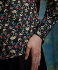Detail of women's skull and rose print cotton blouse with long sleeve and wide cuff