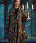 Front view of the ModCloth Midnight Soirée Dress Coat in Memento Mori featuring skull buttons, long sleeves, and a vintage-inspired silhouette.
