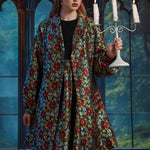 Front view of the ModCloth Midnight Soirée Dress Coat in Memento Mori featuring skull buttons, long sleeves, and a vintage-inspired silhouette.