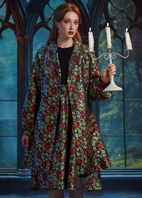 Front view of the ModCloth Midnight Soirée Dress Coat in Memento Mori featuring skull buttons, long sleeves, and a vintage-inspired silhouette.
