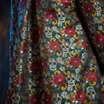 Close-up of the Memento Mori jacquard fabric highlighting the woven floral and sugar skull motif.