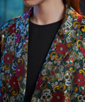 Close-up of the notched lapels on the Midnight Soirée Dress Coat showcasing the intricate floral sugar skull jacquard weave.