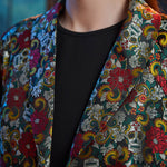 Close-up of the notched lapels on the Midnight Soirée Dress Coat showcasing the intricate floral sugar skull jacquard weave.