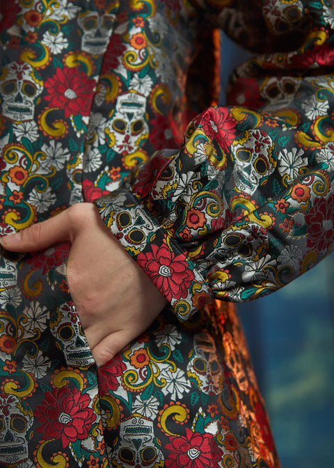 Close-up of the Midnight Soirée Dress Coat sleeve and side seam pocket showcasing the richly woven Memento Mori jacquard fabric.