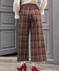 Back view of women's brown plaid culotte pants with center back zipper