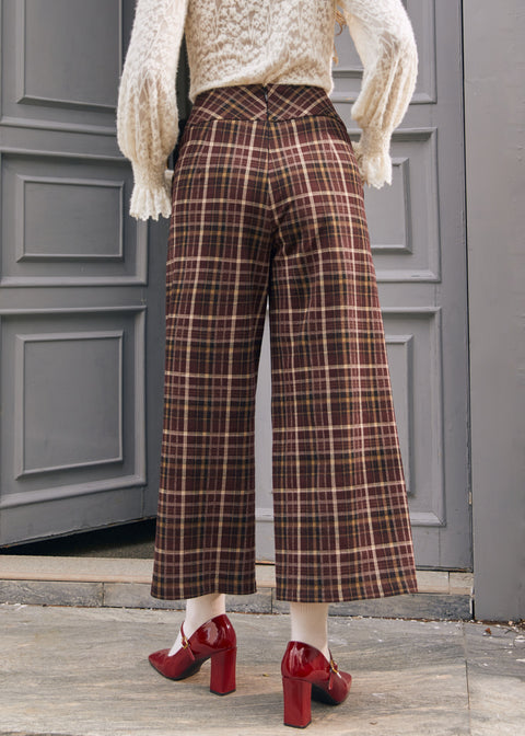 Back view of women's brown plaid culotte pants with center back zipper