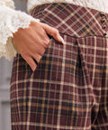 High waisted plaid pants with shaped waistband and decorative metal buttons