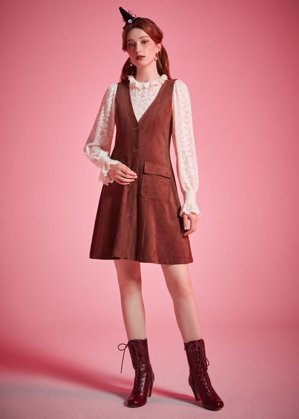 Woman wearing vintage-inspired brown jumper mini dress with blouse and ankle boots