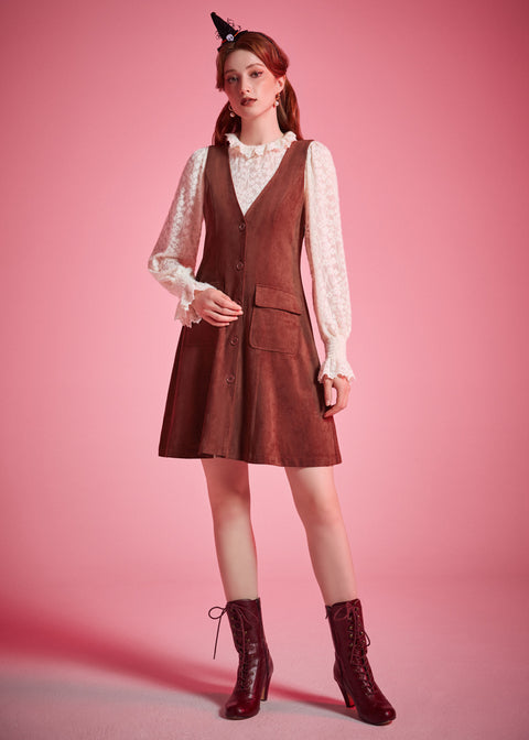 Woman wearing vintage-inspired brown jumper mini dress with blouse and ankle boots