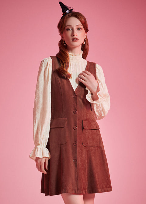 Woman wearing 1970s-inspired A-line jumper dress with deep V-neck and front buttons