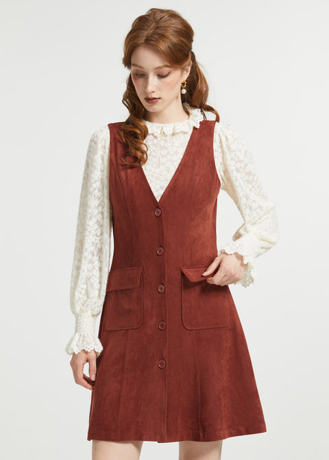 Woman styling rust brown sleeveless jumper dress with cream blouse