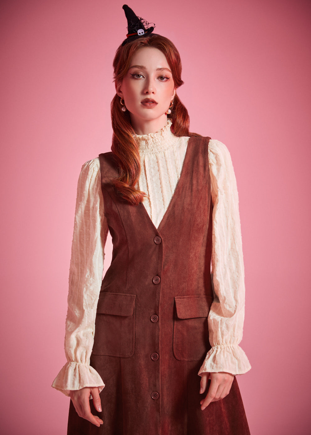 Woman wearing ModCloth button front jumper dress with patch pockets in Autumn Auburn