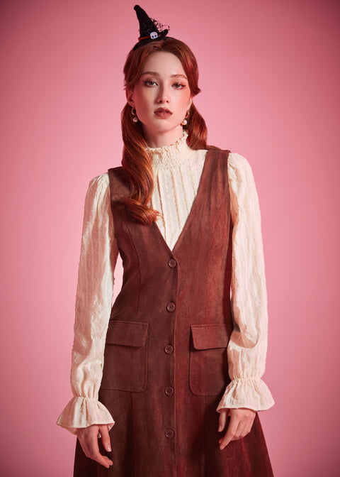 Woman wearing ModCloth button front jumper dress with patch pockets in Autumn Auburn
