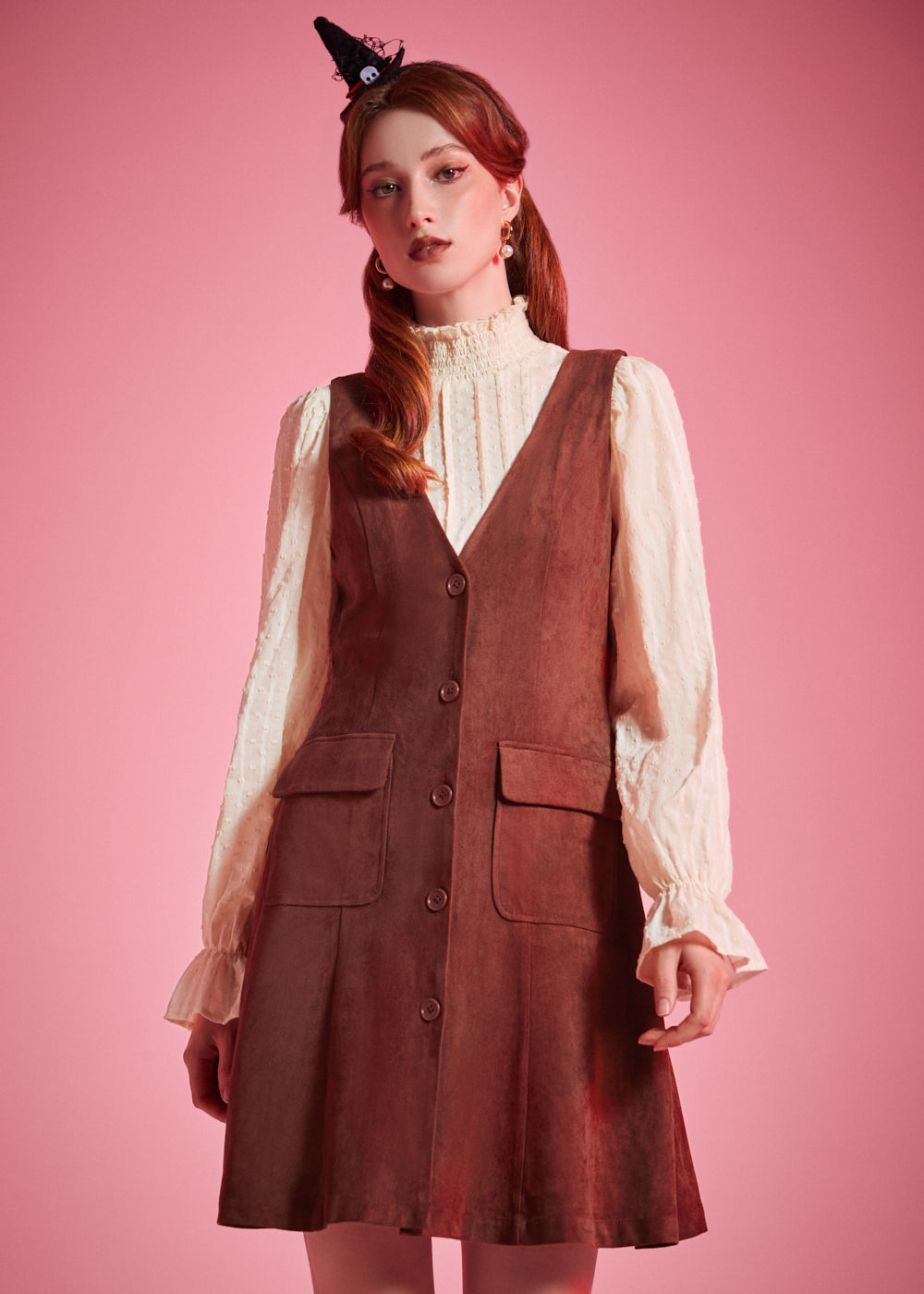 Woman wearing Study Hall Sweetheart jumper dress in Autumn Auburn with patch pockets