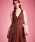 Woman wearing Study Hall Sweetheart jumper dress in Autumn Auburn with patch pockets