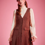 Woman wearing Study Hall Sweetheart jumper dress in Autumn Auburn with patch pockets