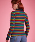 Back view of women's rainbow striped long sleeve polo top with black contrast collar