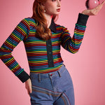 Women's fitted rainbow stripe polo top with long sleeves, black cuffs, and button-front placket