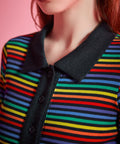 Close-up of rainbow striped rib knit polo top with black point collar and functional button placket