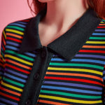 Close-up of rainbow striped rib knit polo top with black point collar and functional button placket