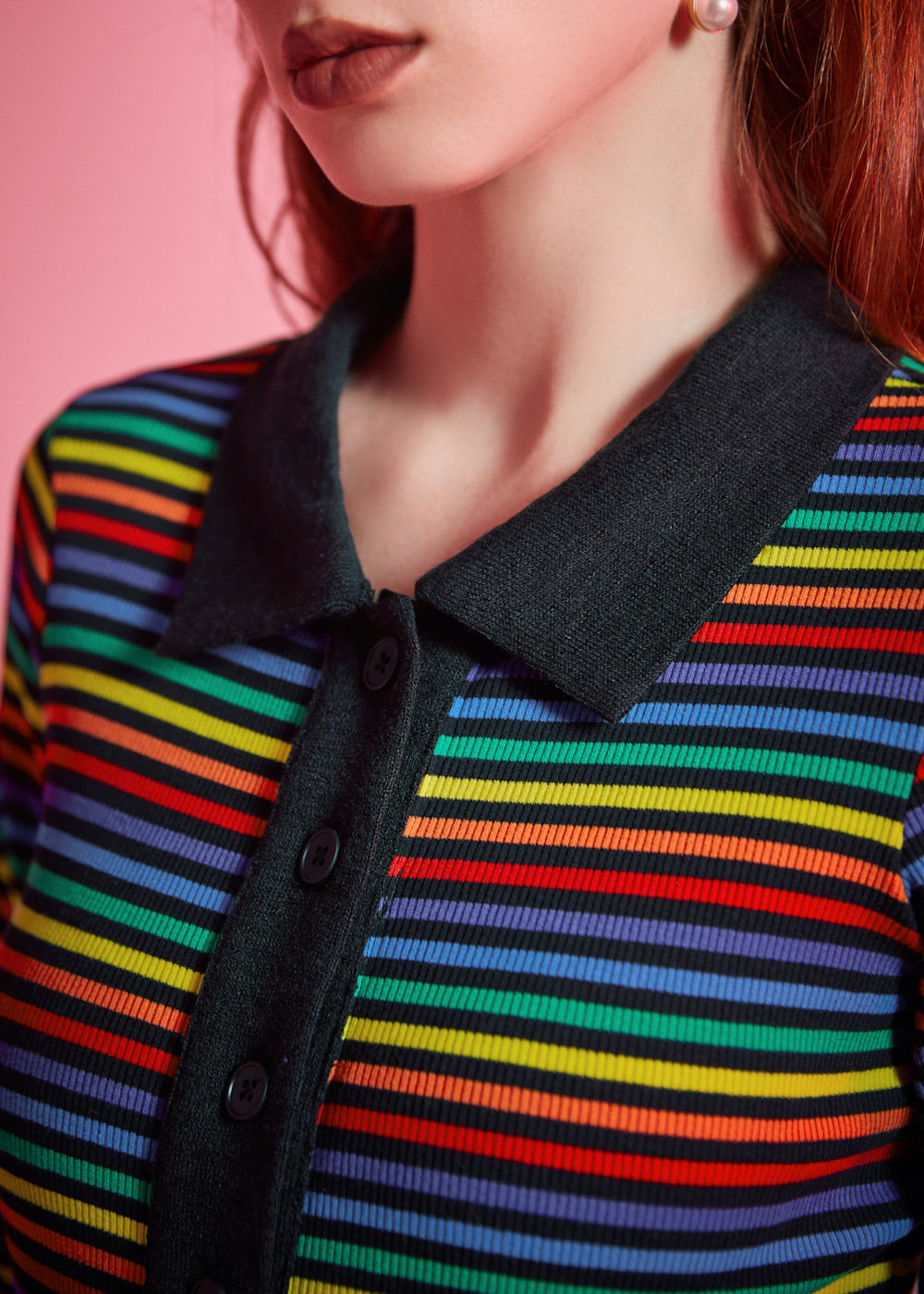 Close-up of rainbow striped rib knit polo top with black point collar and functional button placket