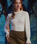 Woman wearing ivory Victorian-inspired lace blouse with high ruffle collar