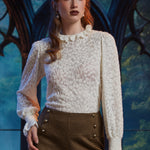 Woman wearing ivory Victorian-inspired lace blouse with high ruffle collar