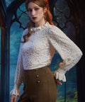 Woman wearing ivory lace ruffle blouse styled with high-waisted houndstooth pants