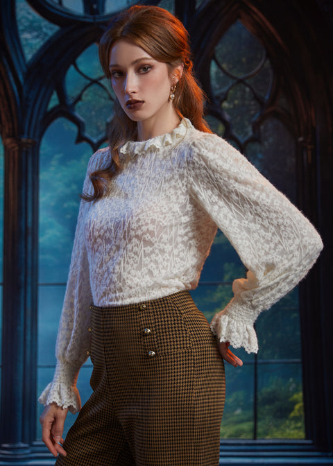 Woman wearing ivory lace ruffle blouse styled with high-waisted houndstooth pants