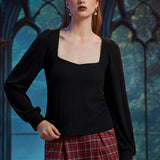 Woman wearing fitted black square neck long sleeve top with softly gathered shoulders and balloon sleeves
