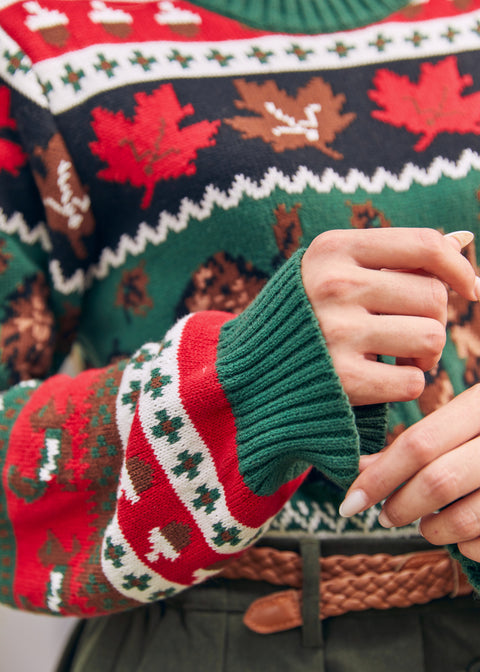 Close-up of women's cotton Fair Isle sweater with maple leaves and woodland pattern