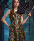 Woman wearing the ModCloth Forever Remembered Dress styled with a black folding fan for an elegant special occasion look.