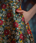 Close-up of the side seam pocket on the Forever Remembered Dress highlighting the textured floral brocade fabric.