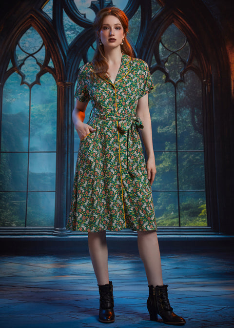 Woman wearing vintage-inspired button-front midi shirt dress with shawl collar, contrast piping, and pockets.