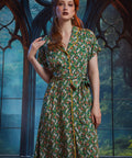 Woman modeling button-front midi dress with removable fabric belt and whimsical frog print.