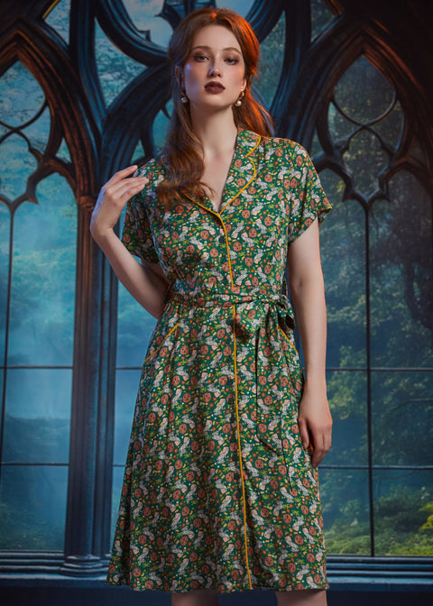 Woman modeling button-front midi dress with removable fabric belt and whimsical frog print.