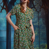 Woman wearing button-front shirt dress with pockets, removable belt, and woodland frog print.