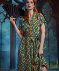 Woman wearing ModCloth Going Out And About button-front midi dress in Toadally Bewitched frog and mushroom print with removable tie belt.
