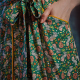 Close-up of front pocket, removable self-tie belt, and Toadally Bewitched frog and mushroom print on a ModCloth dress.