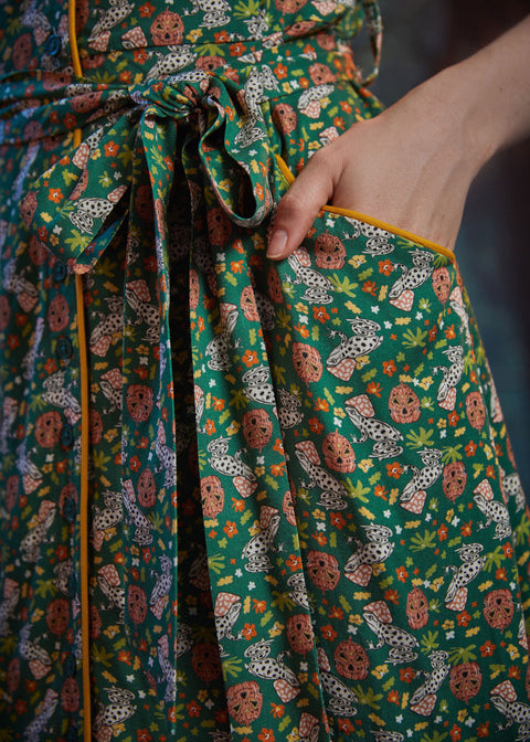 Close-up of front pocket, removable self-tie belt, and Toadally Bewitched frog and mushroom print on a ModCloth dress.