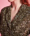 Close-up of olive floral print and tailored collar on vintage-inspired dress
