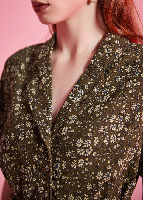 Close-up of olive floral print and tailored collar on vintage-inspired dress