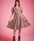 Vintage-inspired burgundy floral dress with full gathered skirt and short sleeves