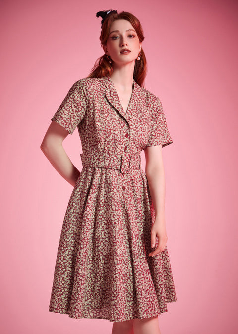 Woman wearing vintage cotton floral dress with flowing fit-and-flare silhouette