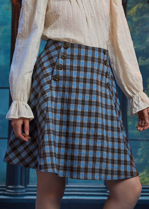 Front close-up of woman wearing the Sailor Flare Skirt in Study Blues with double button details and blue brown plaid pattern