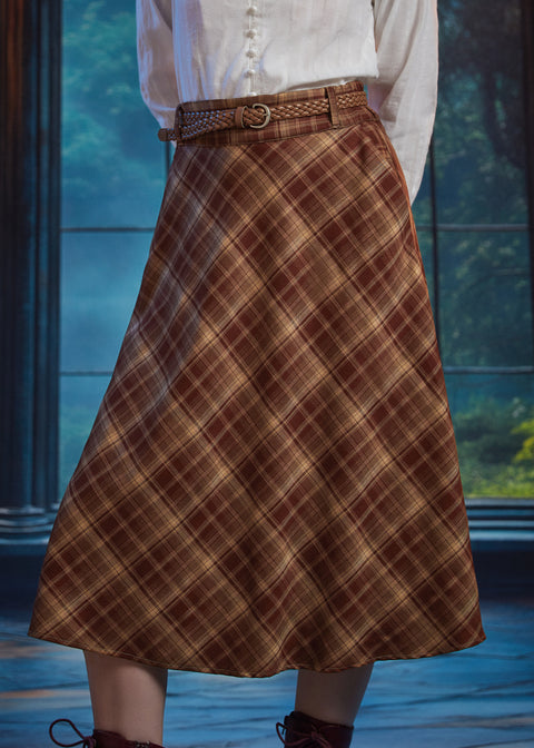 Angled view of woman wearing high-waisted brown plaid midi skirt with braided belt and bias-cut A-line silhouette